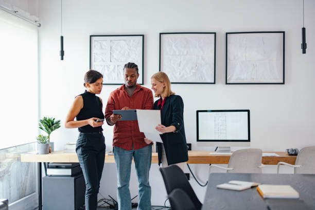 istock Young Coworkers Collaborating in a Modern Design Studio on a Business Project 2193393928