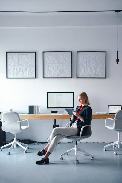 istock Professional Woman in a Contemporary Office Workspace Using a Digital Tablet 2193393938
