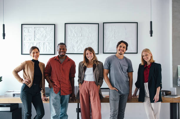 istock Young Diverse Team of Designers Posing Confidently in Modern Design Studio 2193393940