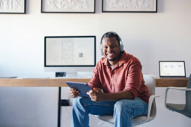 istock Confident Professional in Comfortable Office Setting with Headphones and Tablet 2193393958