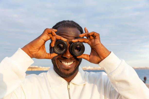 istock Afro man holding lens in eyes 2193395404
