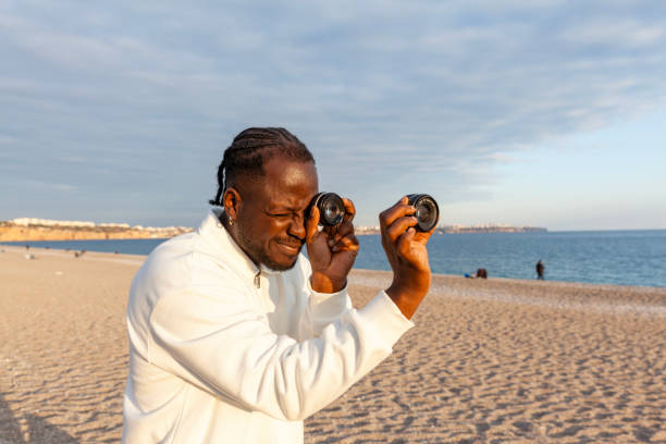 istock Afro man holds lenses to  eyes and makes a telescope 2193395412