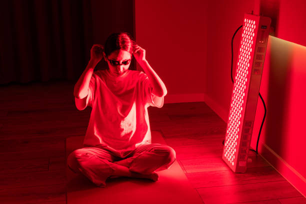 istock Woman adjusting eye protection for red light therapy session 2193395791