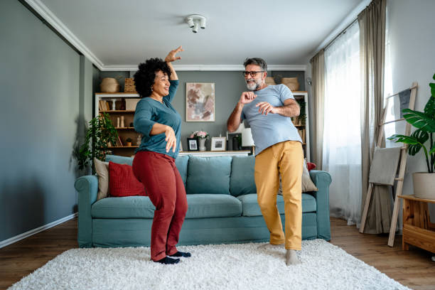 istock Happy mature couple dancing at home 2193396589