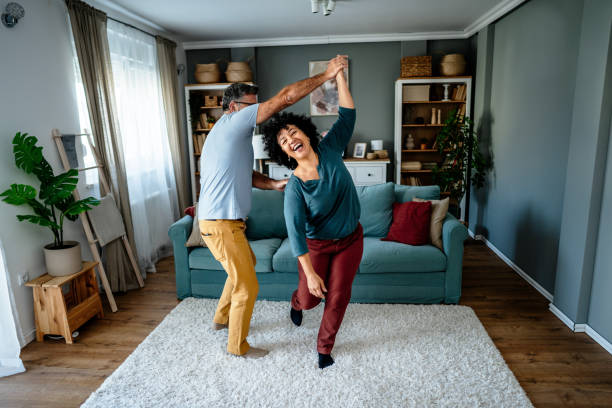 istock Happy mature couple dancing at home 2193396671