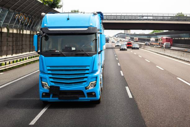 istock Long vehicle truck with tank trailer on a highway. 2193397184