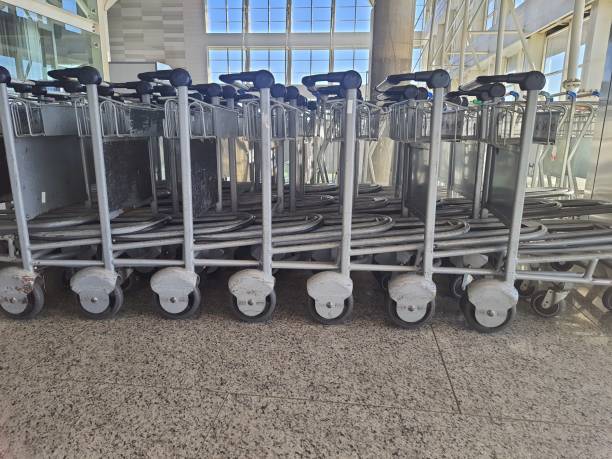 istock Airport luggage carts lined up. 2193398068