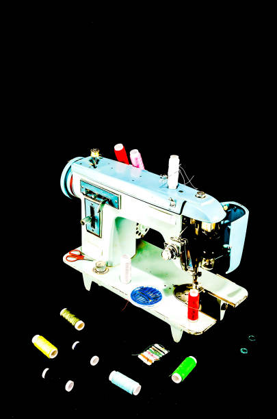 A sewing machine with a bunch of colorful thread spools on it. The machine is blue and white