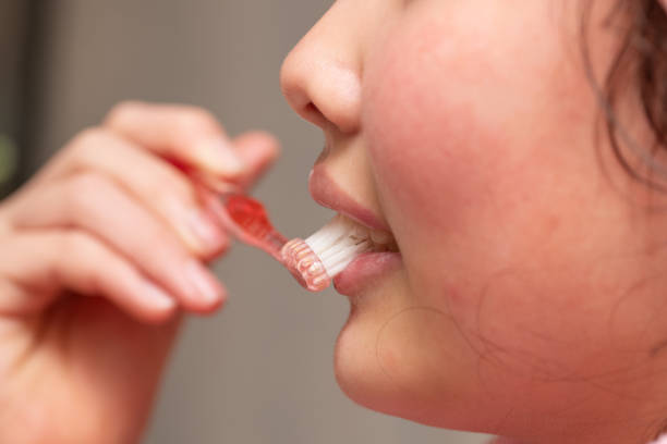 istock Girl in pajamas brushing her teeth 2193399692