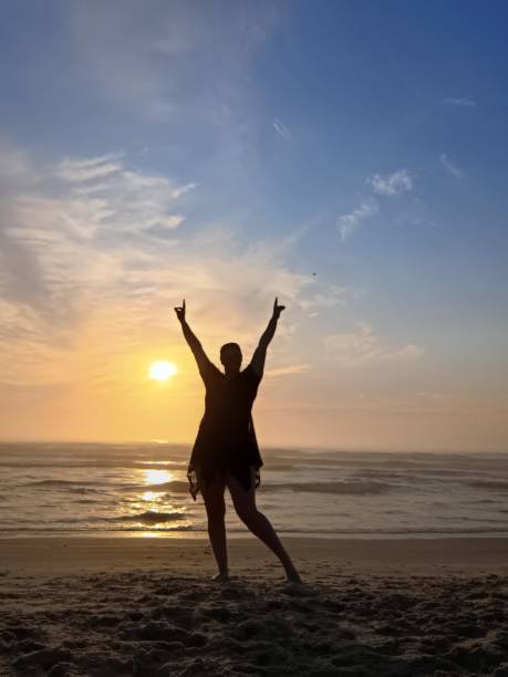 istock happy woman at sunrise 2193401931