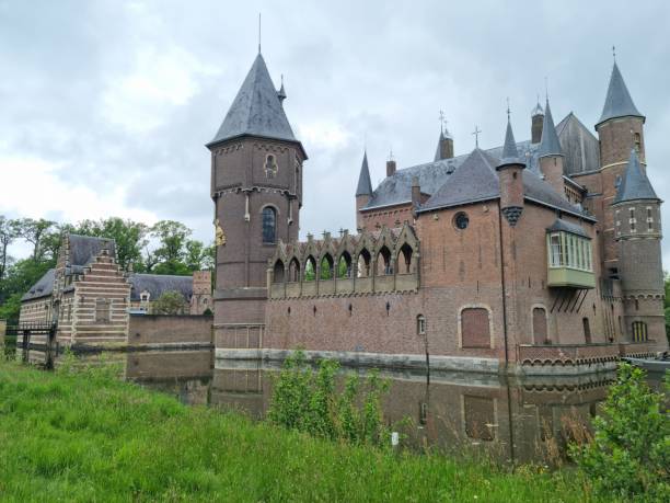 S-Hertogenbosch, Netherland - May 08, 2024: Well preserved medieval Heeswijk Castle surrounded with river surrounding it