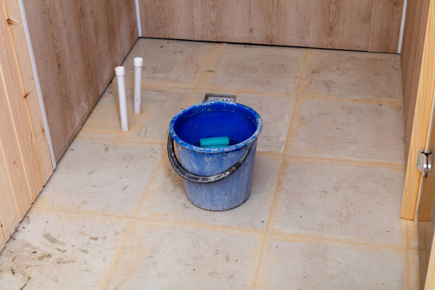 istock A blue bucket with a sponge in it sits on a tile floor 2193407506