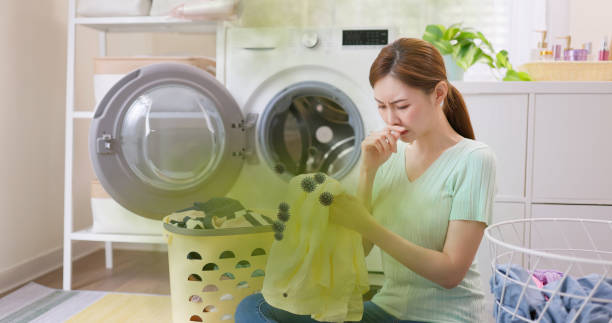 istock woman take clothes from washer 2193409790