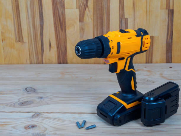 istock A screwdriver-drill against a wood background, ready for work, is ideal for repairs and construction in the country or at home 2193411432