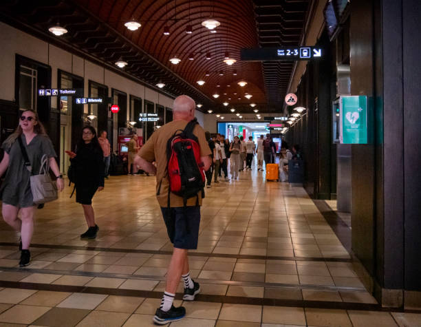 People inside a corridor at Aarhus railway station which connects with a large shopping mall, Bruuns Galleri. Aarhus is a port city in eastern Jutland, mainland Denmark.