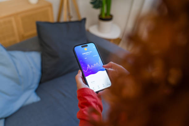istock Woman checking cryptocurrency bitcoin price chart on smartphone at home 2193413484