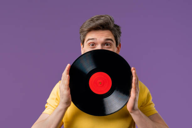 istock Handsome Man Dancing Vinyl Record Disc On Violet. Hobby, Music Lover, Collection 2193416095