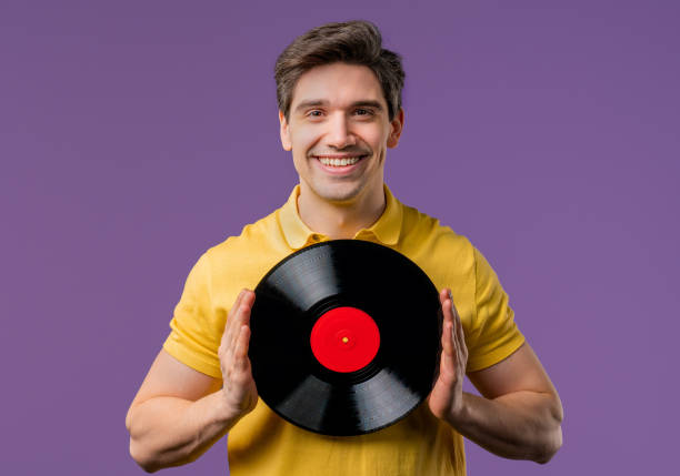istock Handsome Man Dancing Vinyl Record Disc On Violet. Hobby, Music Lover, Collection 2193416112