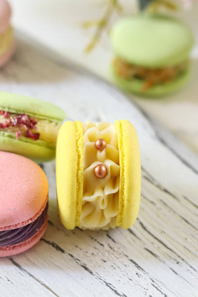 Colorful macarons displayed on a rustic table capture the essence of a delightful pastry shop experience