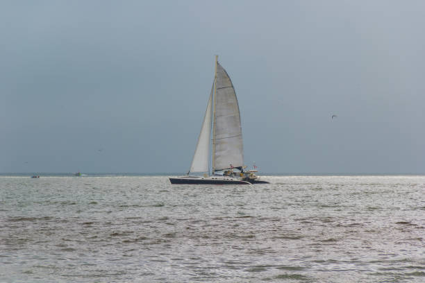 Barranco District, Lima, Peru - November 30, 2024: Sailboat at Playa Las Sombrillas (Umbrellas Beach)