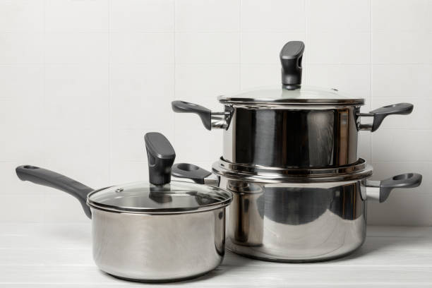 istock Stainless steel saucepan on light kitchen background. Modern saucepan. Kitchenware. Cooking pot. Cooking concept. Mockup. Space for text. Copy space. 2193427552