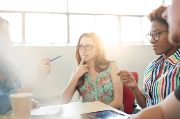 istock Unposed group of adult student in an open concept class collaborating on their next project. 2193431781