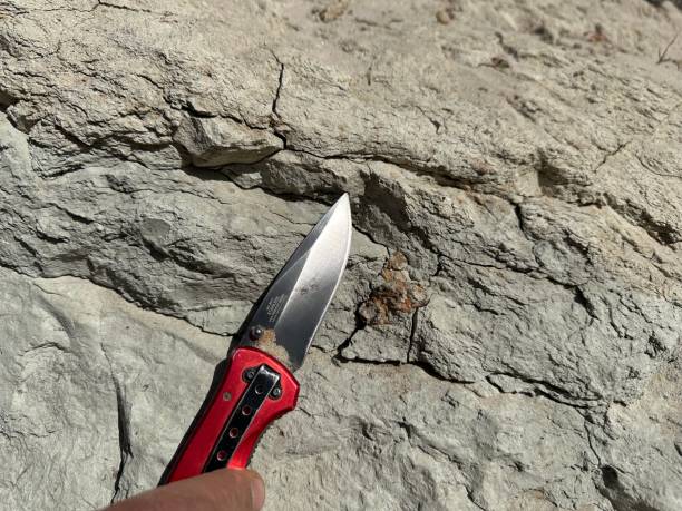 istock A knife against a background of petrified clay. 2193432322