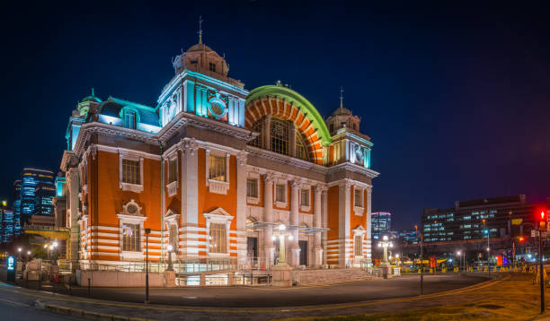 The historic facade of Osaka Central Public Hall spotlit at night, iconic symbol of Japan's vibrant second city, between the skyscrapers of downtown.