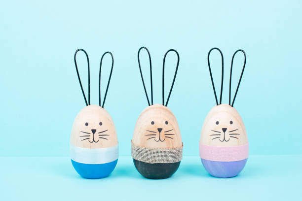 istock Easter bunny or rabbit group, holiday background and greeting card, painted wooden egg 2193433981
