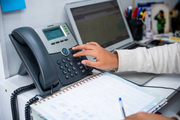 istock A woman hand dialing a phone at home while is working remotely 2193434213
