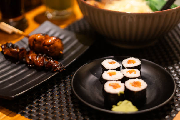 istock Salmon Sushi with Chopsticks in Japanese Dining Setting 2193434227