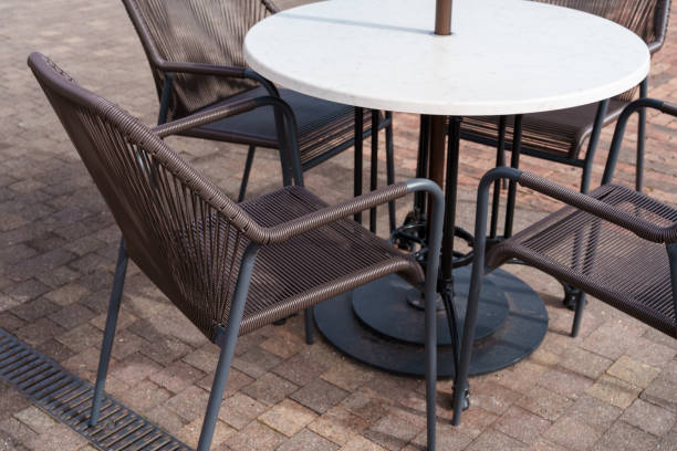 istock Relaxing Open-Air Cafe Space with Modern Table and Chairs 2193434725