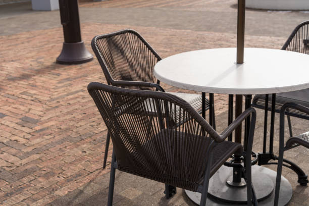 istock Relaxing Open-Air Cafe Space with Modern Table and Chairs 2193434873