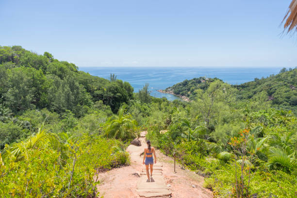 istock Young woman hikes down jungle trail 2193439826