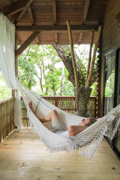 istock Young woman hangs in hammock 2193440225