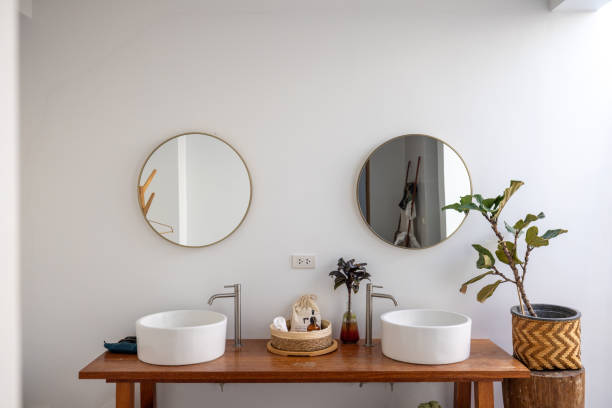 istock Minimalist bathroom vanity with twin round mirrors and chic decor 2193441915