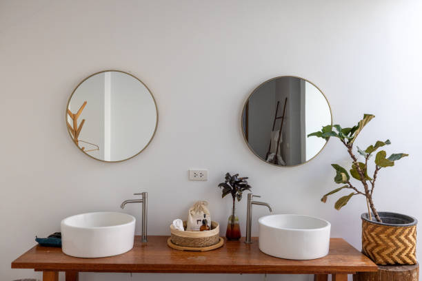 istock Minimalist bathroom vanity with twin round mirrors and chic decor 2193441938