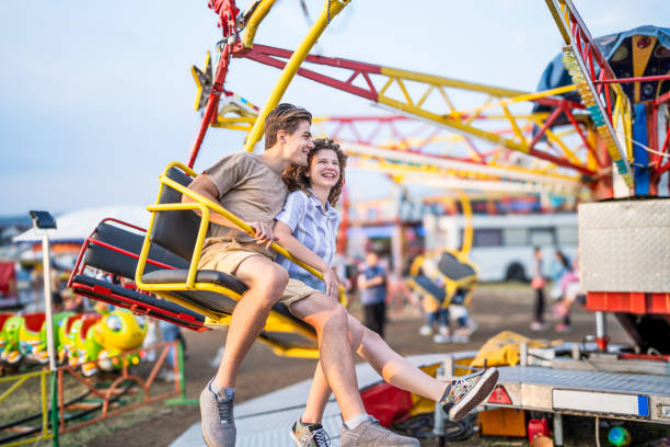 istock Couple on the carousel in an amusement park 2193442154