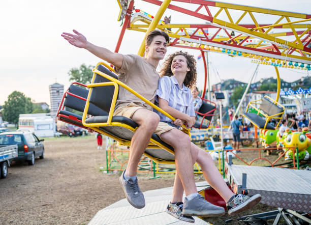 istock Couple on the carousel in an amusement park 2193442191