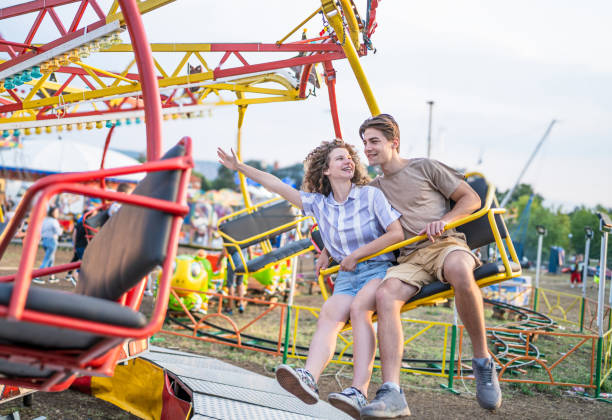 istock Couple having fun in an amusement park 2193442201