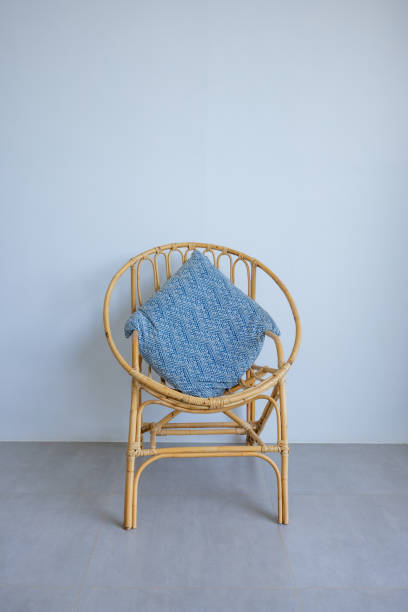 istock A Rattan Chair with Blue Cushion in Minimalist Setting 2193442452