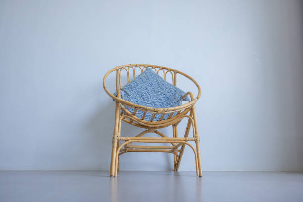 istock A Rattan Chair with Blue Cushion in Minimalist Setting 2193442471
