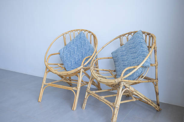 Two rattan chairs with blue tie-dye cushions, offering a coastal vibe. Ideal for minimalist interiors. Perfect for home decor and furniture design inspiration.