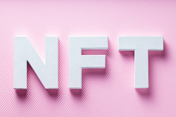 istock NFT White Letters on Pink Diagonal Striped Background, Crypto Art Concept, Top View 2193443841