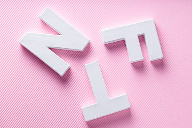 NFT White Letters on Pink Diagonal Striped Background, Crypto Art Concept, Top View