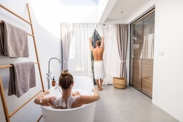 istock Relaxed Couple in Modern Bathroom with Natural Light 2193444701