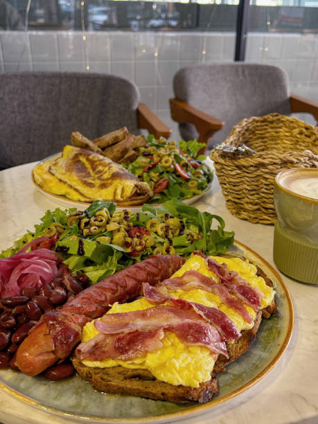 istock A hearty spring brunch in an Istanbul cafe featuring scrambled eggs, crispy bacon, sausages, salads, and a latte, captured in warm daylight indoors 2193444853