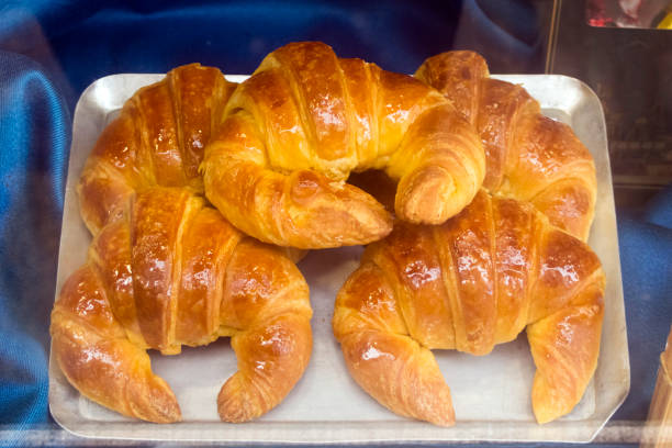 Heap of fresh baked French croissants on tray ready to eat. Bakery.cafeteria. Galicia Spain.