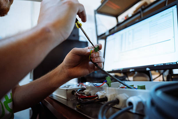 istock Electronic components assembly in factory with qualified diverse employees. Technician fixing the electronic parts 2193447193