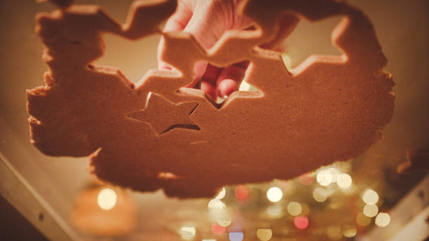 istock Cutting out gingerbread cookies on a countertop. Shot from below. 2193447327